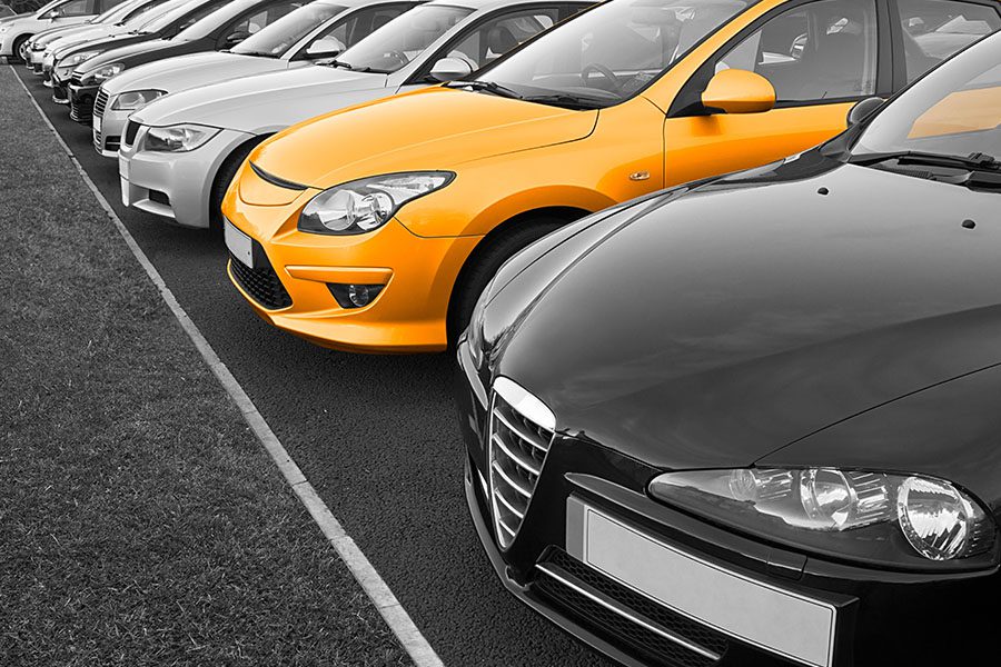 Blog - Angled View of a Fleet of New Business Cars With One of the Cars Being Yellow